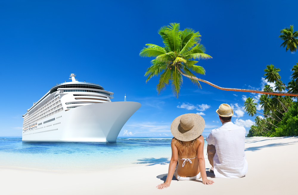 Couple on a beach vacation. Cruise ship in the background.